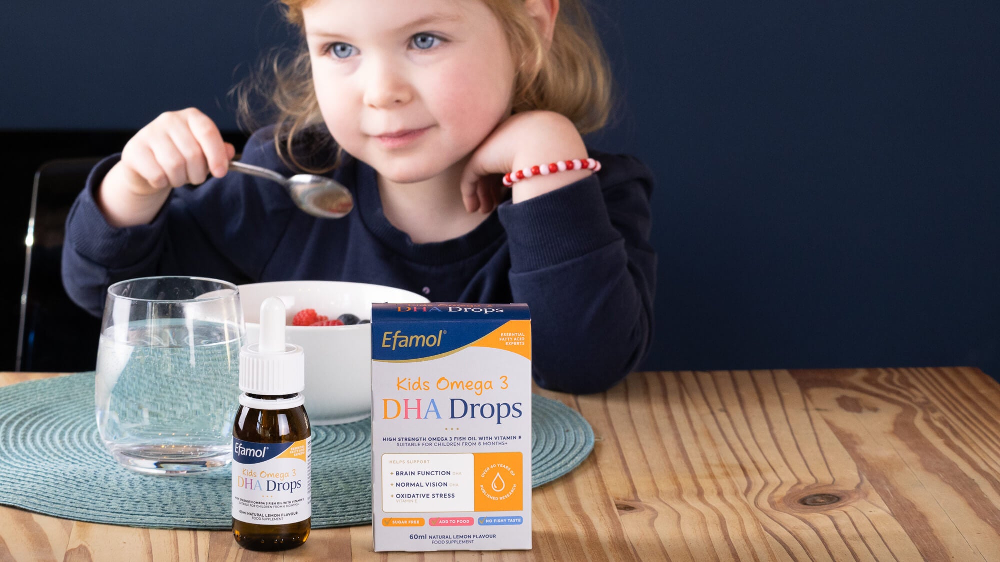 Efamol Kids DHA Drops at breakfast time with young girl Efamol Kids DHA Drops at breakfast time with young girl