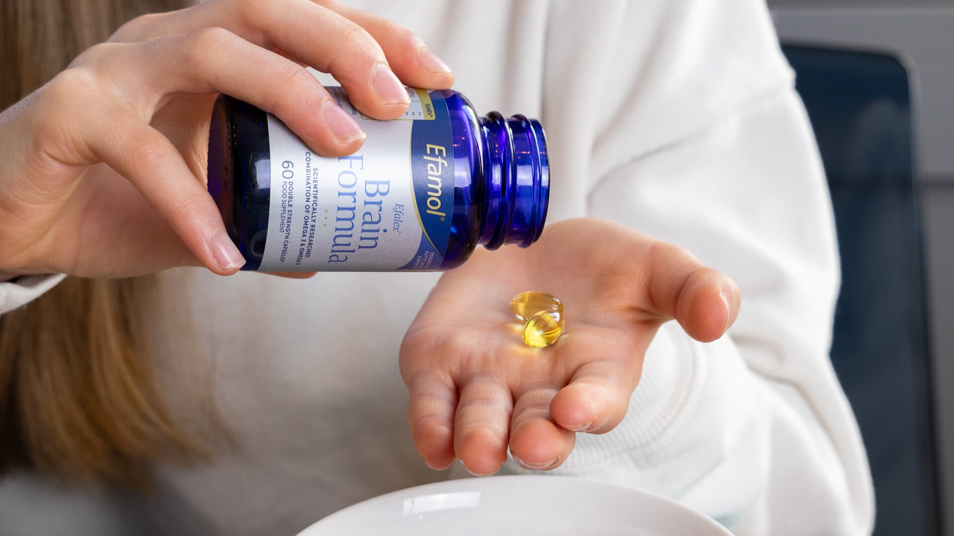 Efamol brain formula Efamol brain formula pouring capsules into hand