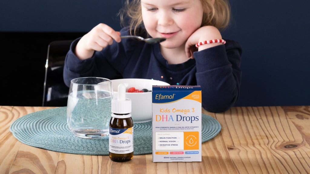 child eating breakfast with Efamol Kids Omega 3 DHA Drops in the foreground