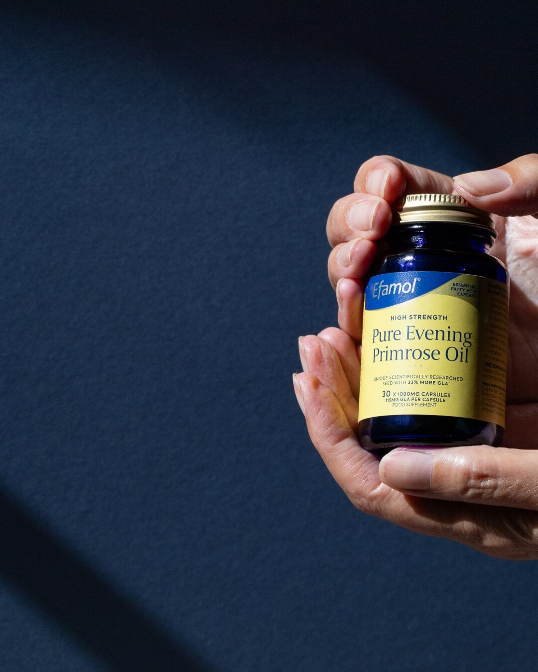 Efamol evening primrose oil 1000mg capsule in hand background