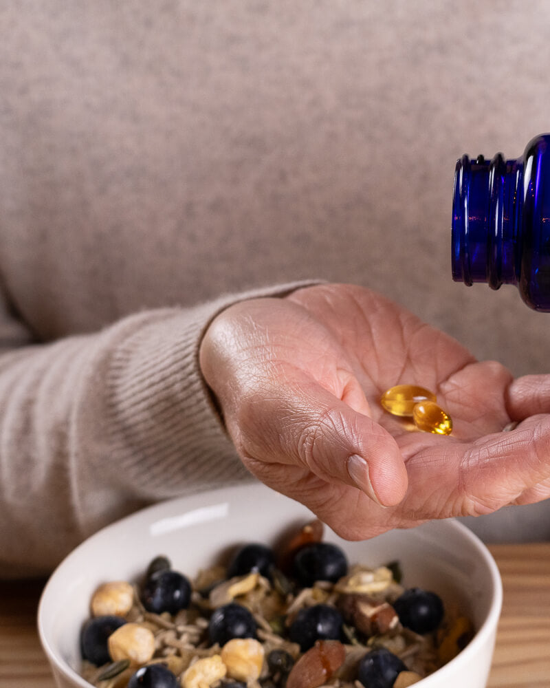 Efamol brain formula pouring capsules into hand