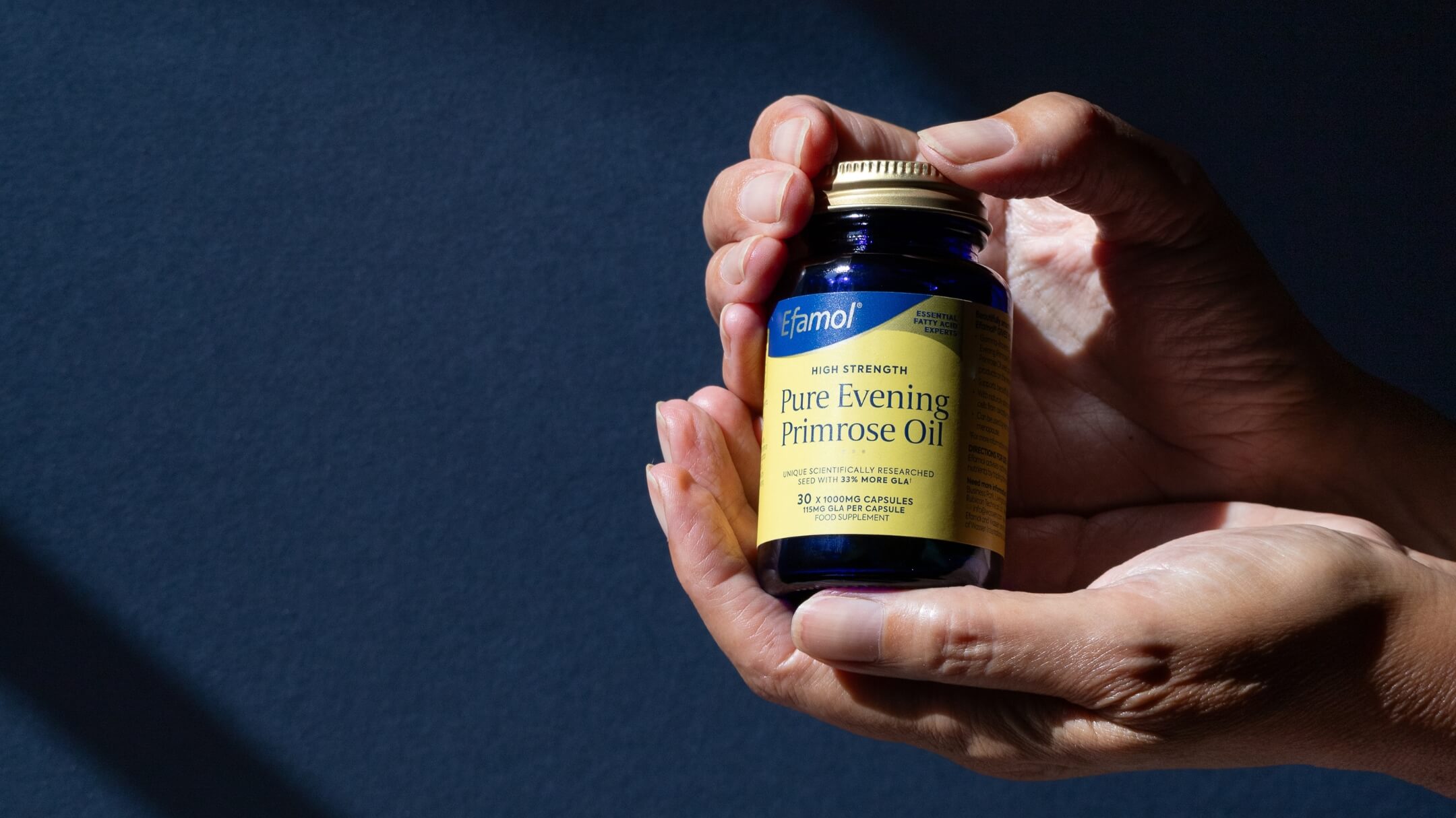 Efamol evening primrose oil 1000mg capsule in hand background