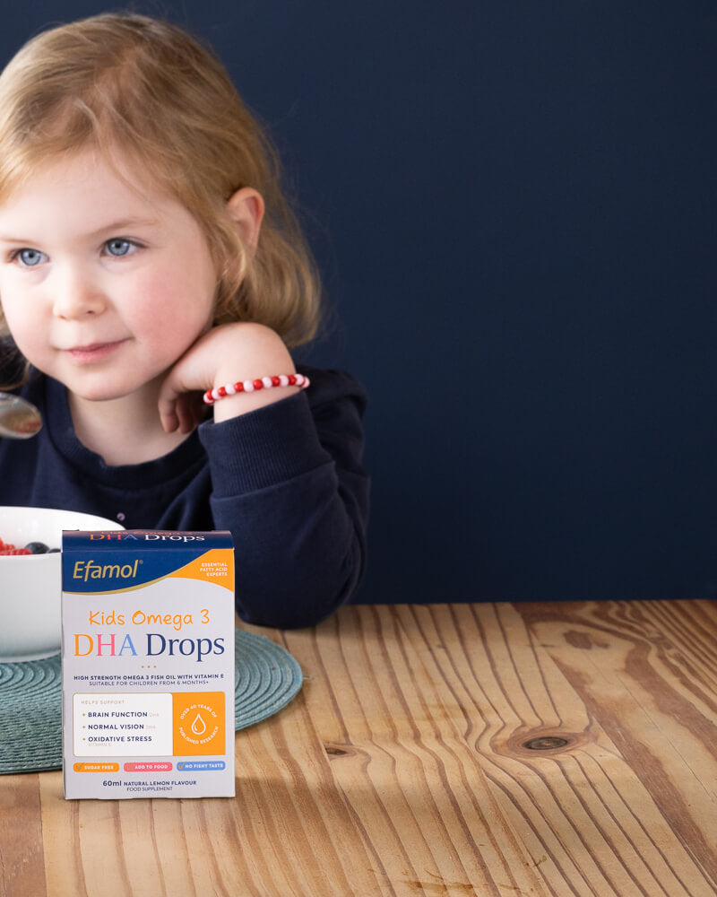 Efamol Kids DHA Drops at breakfast time with young girl